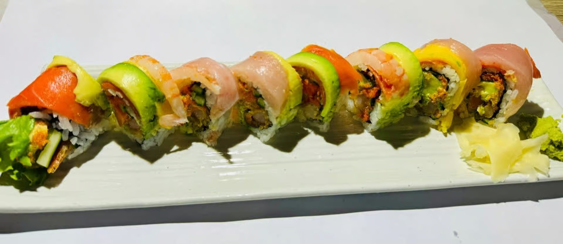 Rainbow Roll - California roll topped with fresh assorted sashimi including tuna, salmon, and avocado